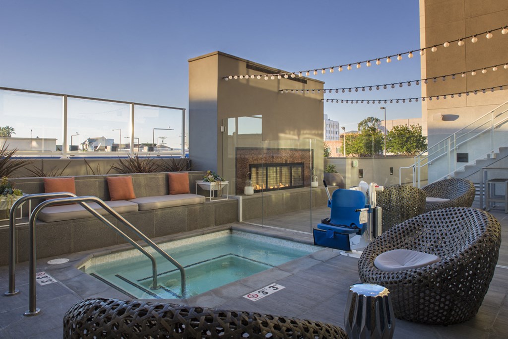 a hot tub on the rooftop of a building with a fireplace