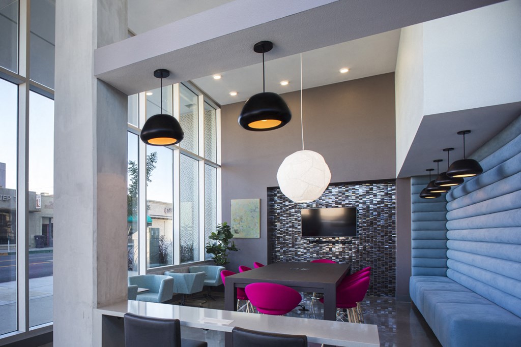 a dining room with a table and chairs and a large window