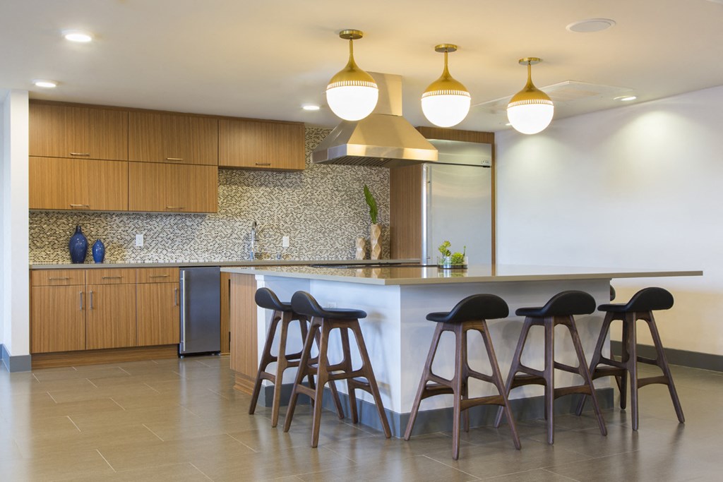 a kitchen with a bar and stools