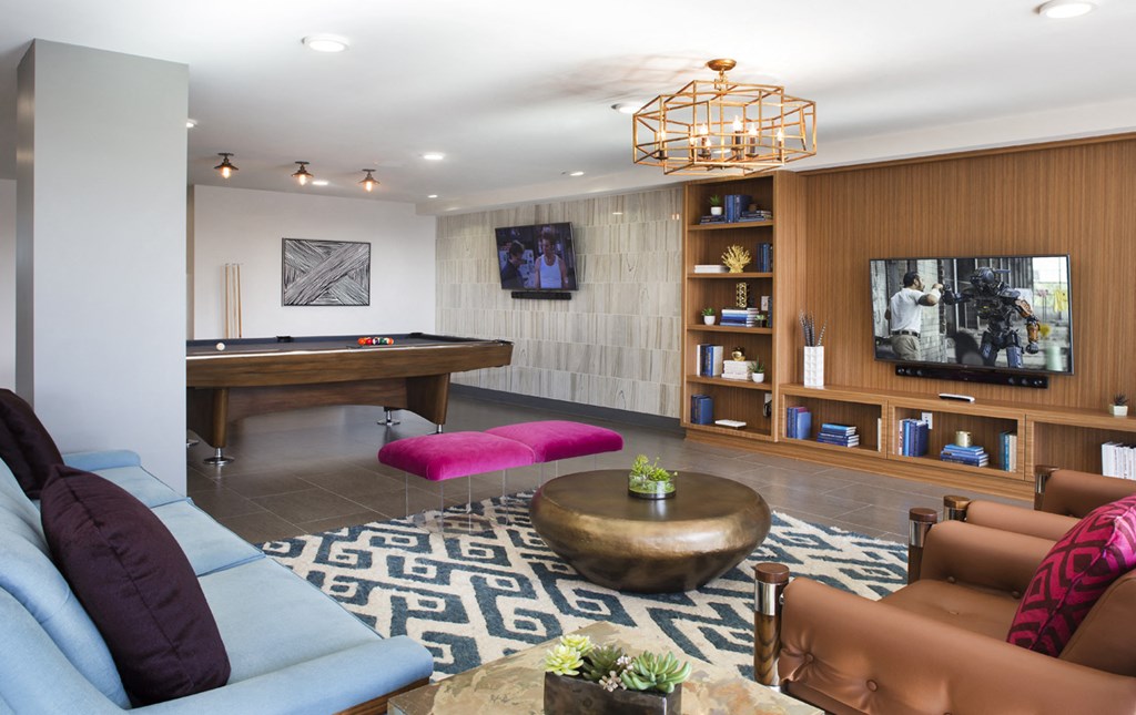 a living room with furniture and a pool table