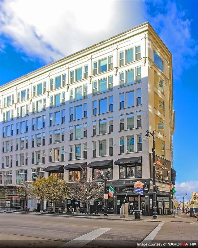 a tall building on the corner of a city street
