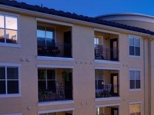 Luxury Apartments in Richardson Texas Open-air swimming pool with spacious tanning deck and lounge seating - Photo Gallery 6