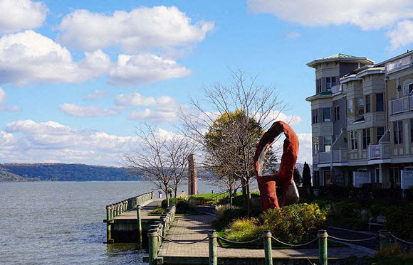 a sculpture on a dock next to a body of water