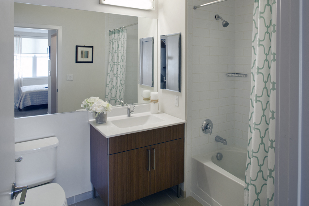 a bathroom with a sink and a shower and a toilet