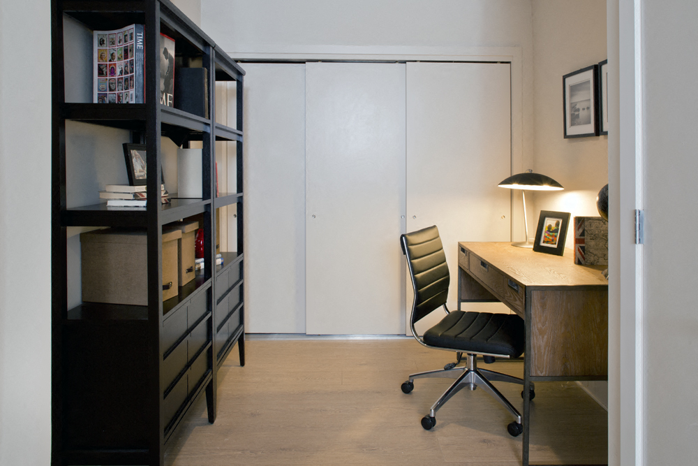 a home office with a desk and a chair