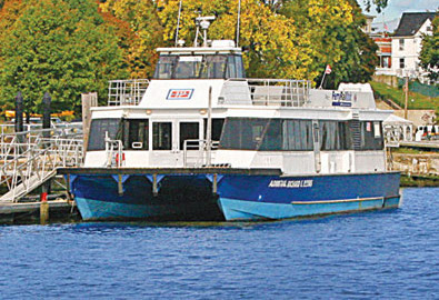 a blue and white boat is docked in the water