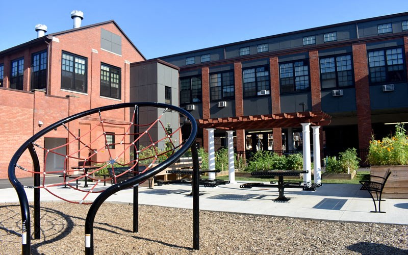 a playground in front of a brick building