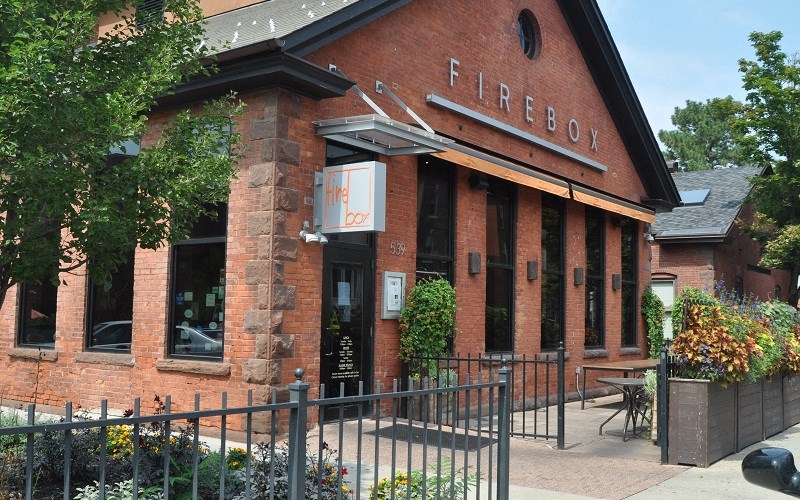 the facade of a firefox restaurant with a wrought iron fence