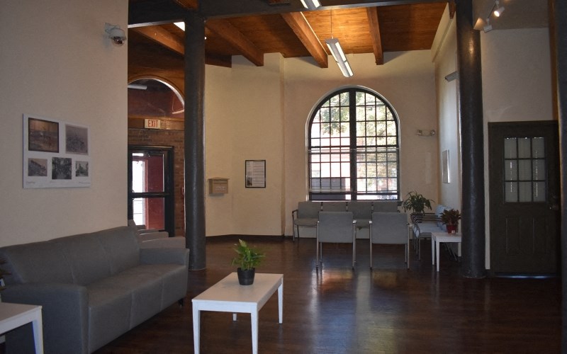 the living room and dining area of a house with a large window
