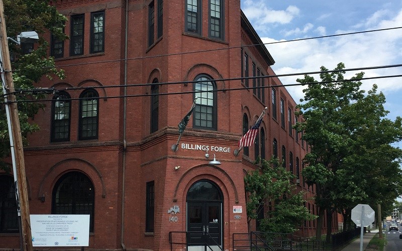 a red brick building with an flag