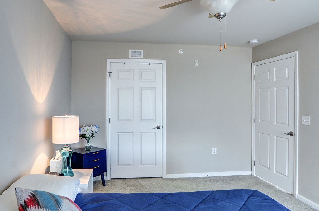 a bedroom with a bed and two closet doors