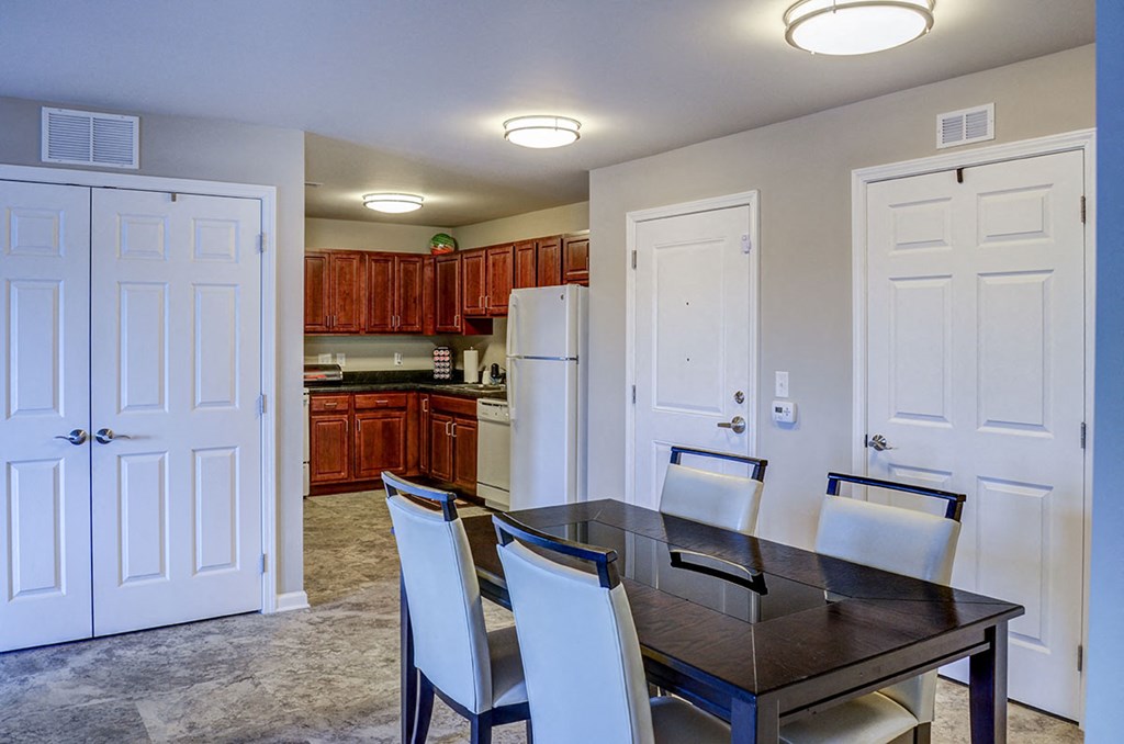 a dining room and kitchen with a table and chairs