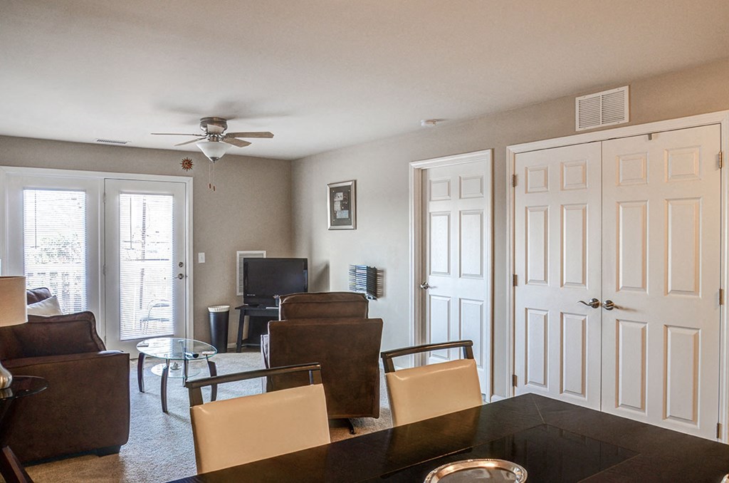 a living room with a couch and a table and a ceiling fan