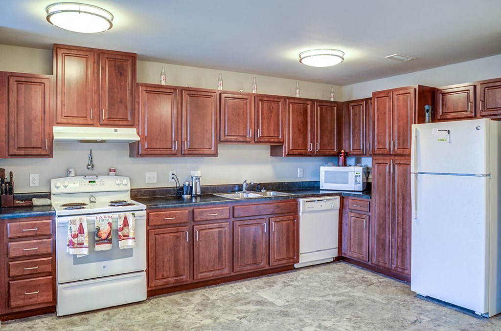 a kitchen with white appliances and wooden cabinets