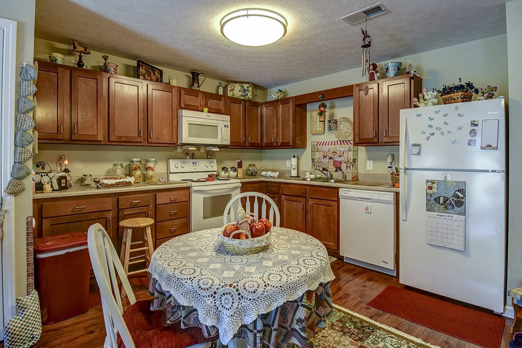 a kitchen with a table and a refrigerator