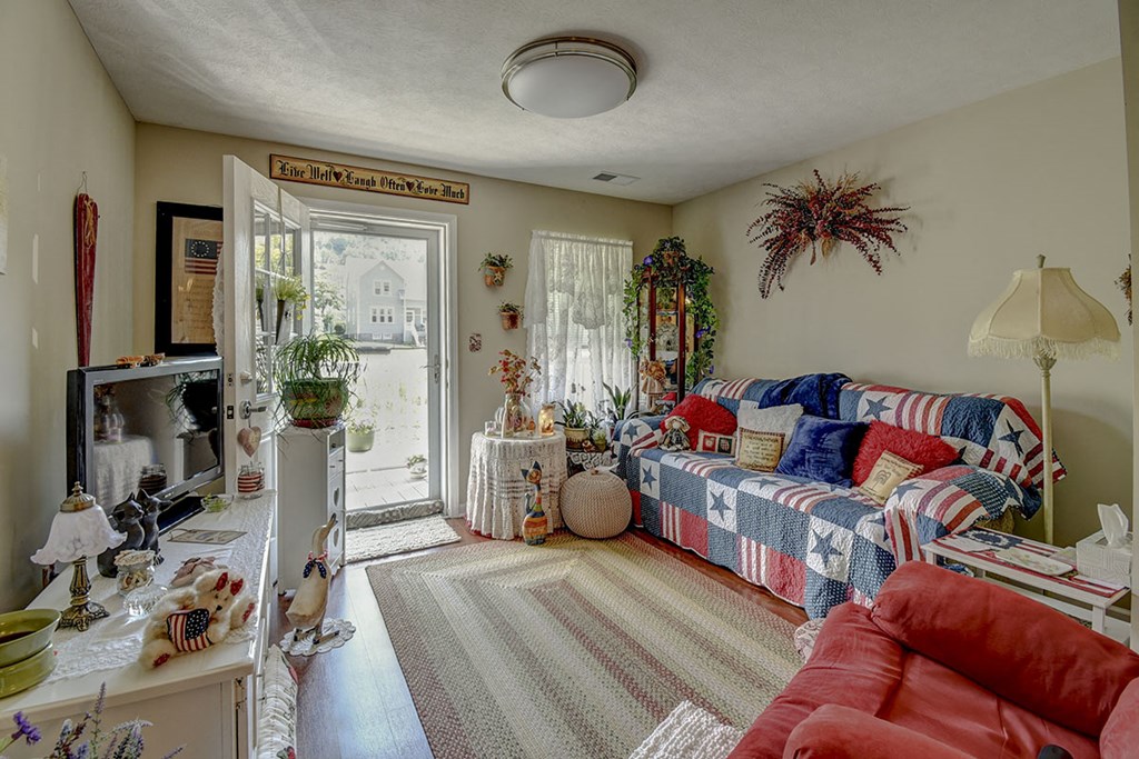 a living room with a couch and a door to a patio