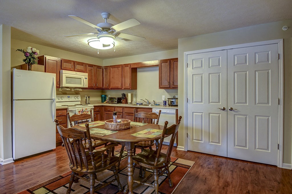 a kitchen with a dining table and a refrigerator