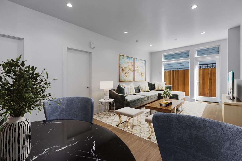 A modern living room with a black marble table and blue chairs.