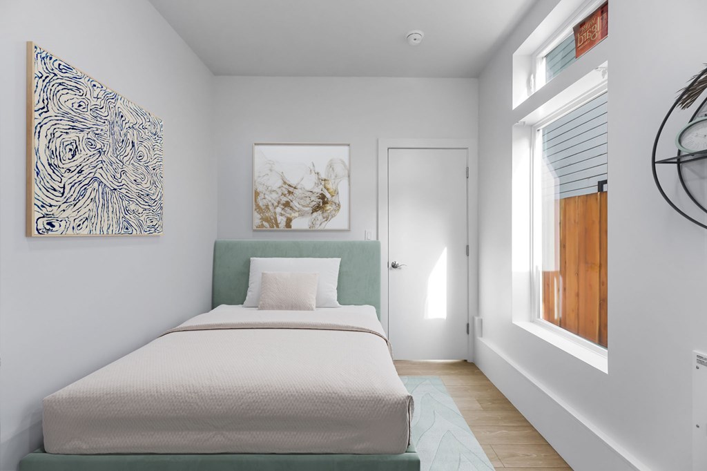 A bedroom with a bed, a painting on the wall, and a door leading to another room.