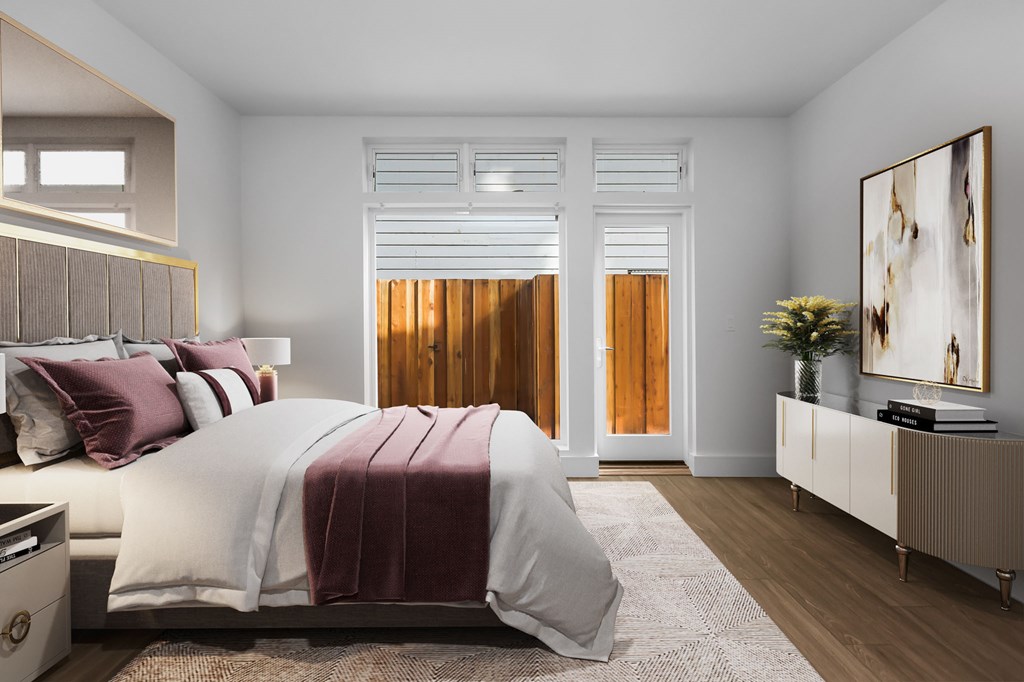 A bedroom with a large bed and a painting on the wall.