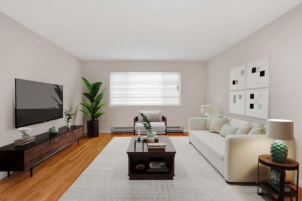 a living room with a white couch and a television