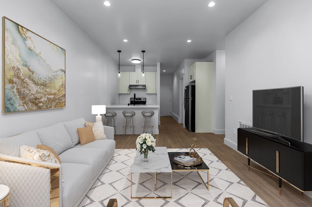 A living room with a white couch, a coffee table, and a painting on the wall.