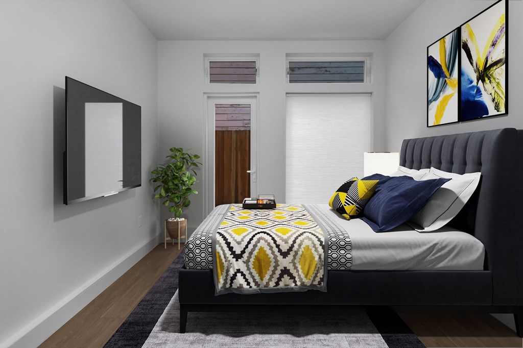 A bedroom with a bed, a mirror, a plant, and a painting on the wall.