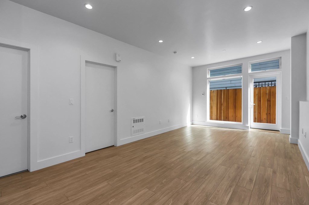 A room with wooden floors and white walls.