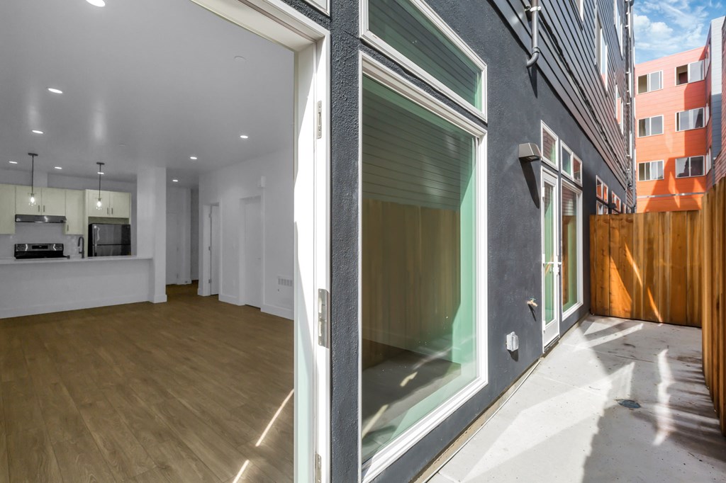 A modern interior with a glass door leading to a balcony.