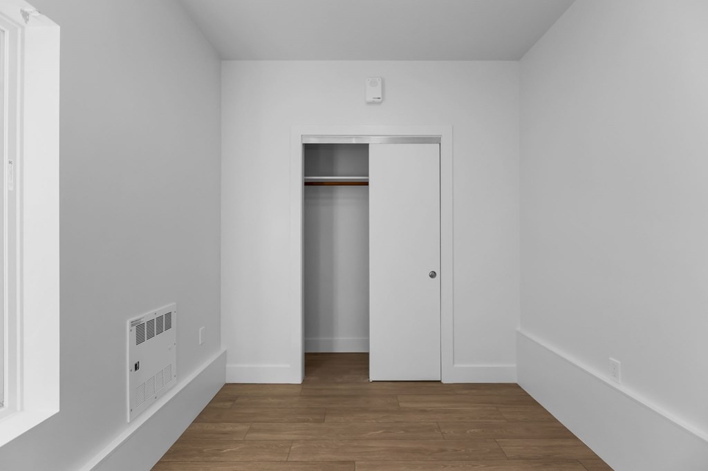 A white door is in the middle of a room.
