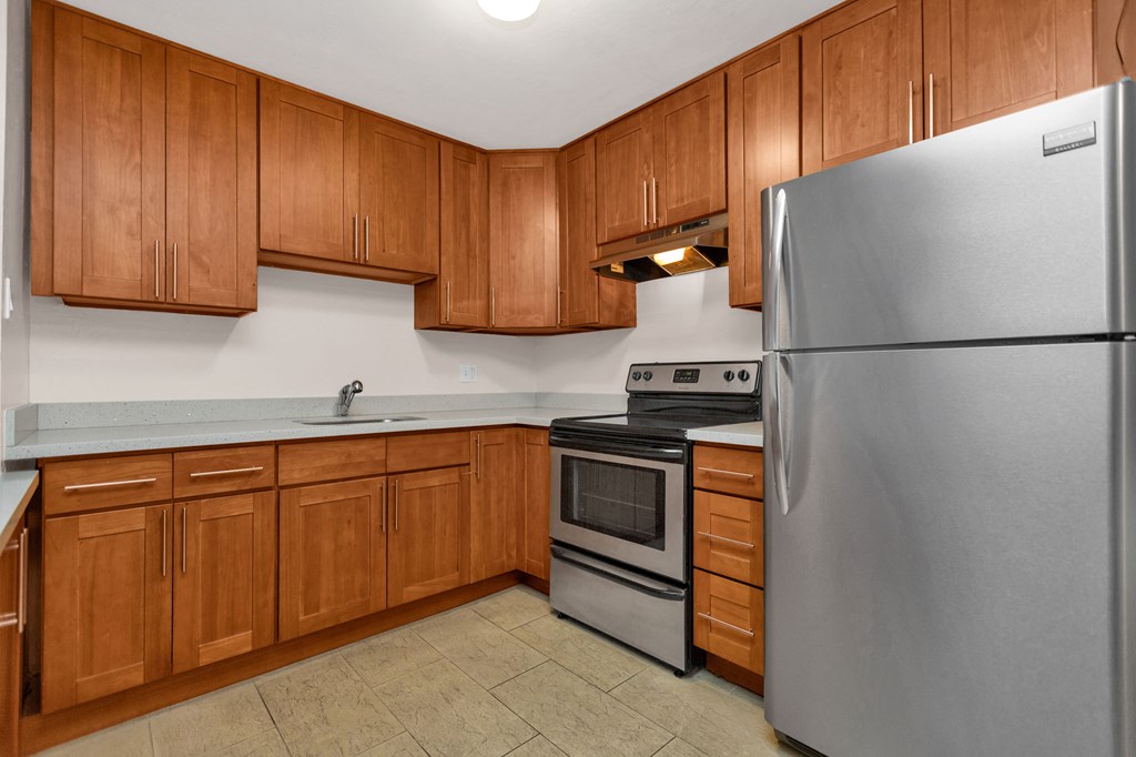 a kitchen with stainless steel appliances and wooden cabinets