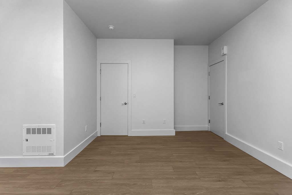 A room with a white wall and a white door.