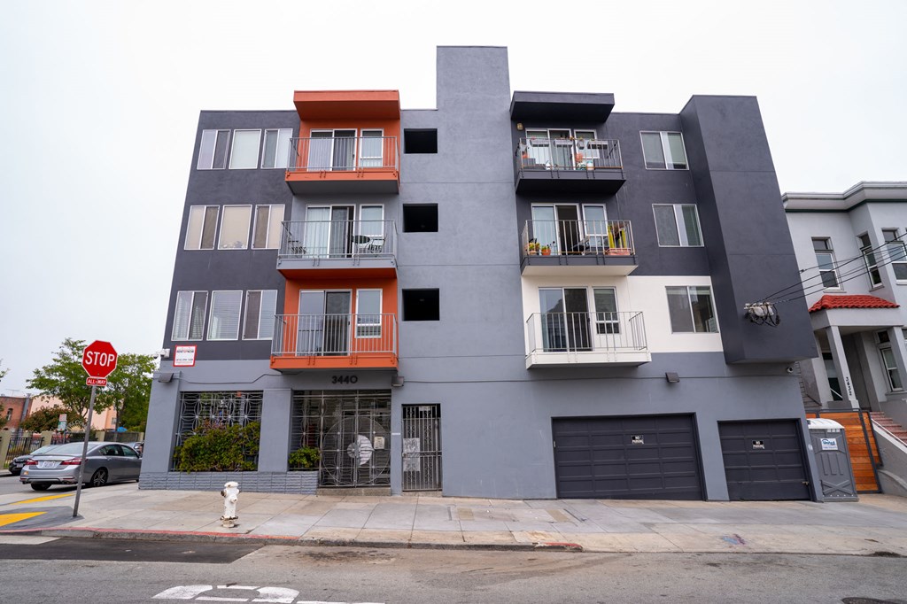 a new apartment building on a city street with a stop sign