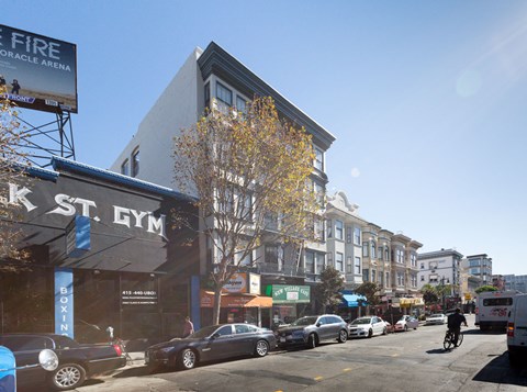A street view of a city with a gym and a fire arena advertisement.