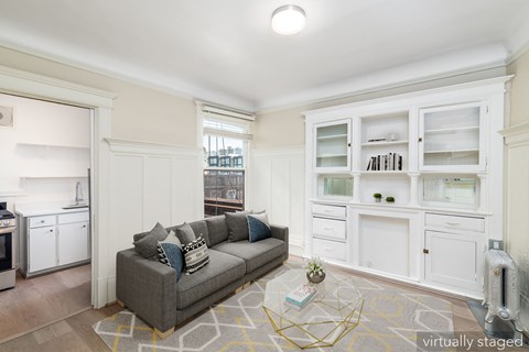 A living room with a grey couch and a coffee table.