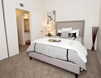 Oakview bedroom Oakview upper unit bedroom has vaulted ceilings with carpet in the bedroom, a closet, window and vertical blinds. The down stairs units do not have vaulted ceilings. - Photo Gallery