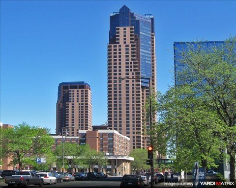 A city street with cars and buildings.