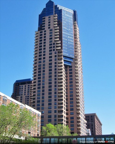 A tall building with a blue sky in the background.