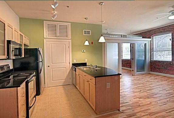 an empty kitchen with a stove and a refrigerator