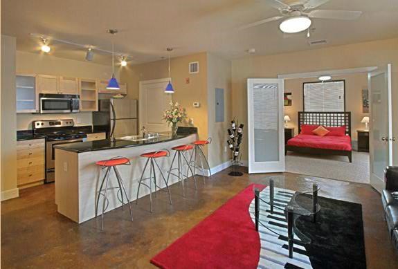 a kitchen with a bar and a living room