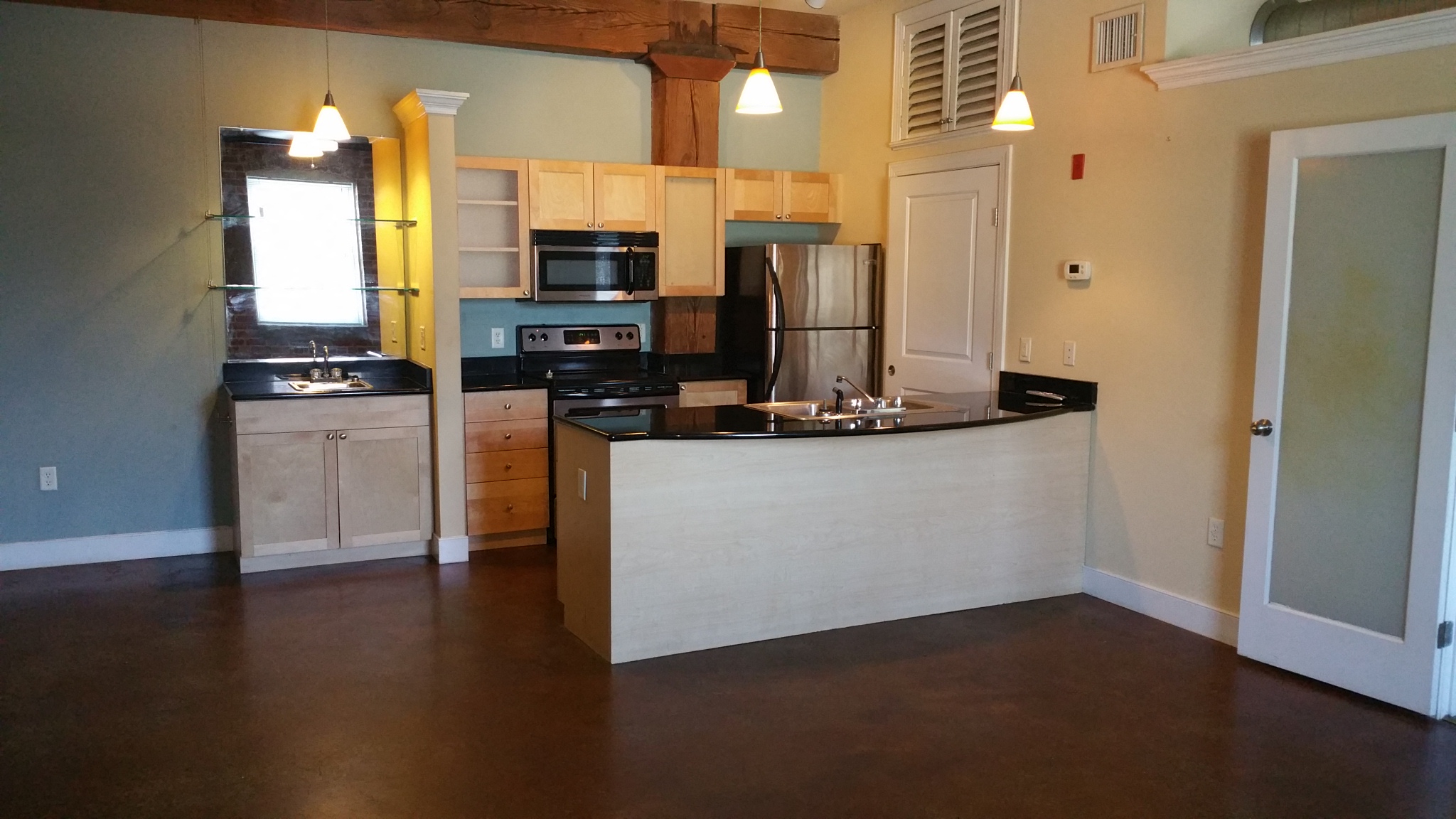 an empty kitchen with an island in the middle