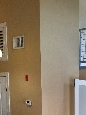 an empty living room with wood floors and a staircase