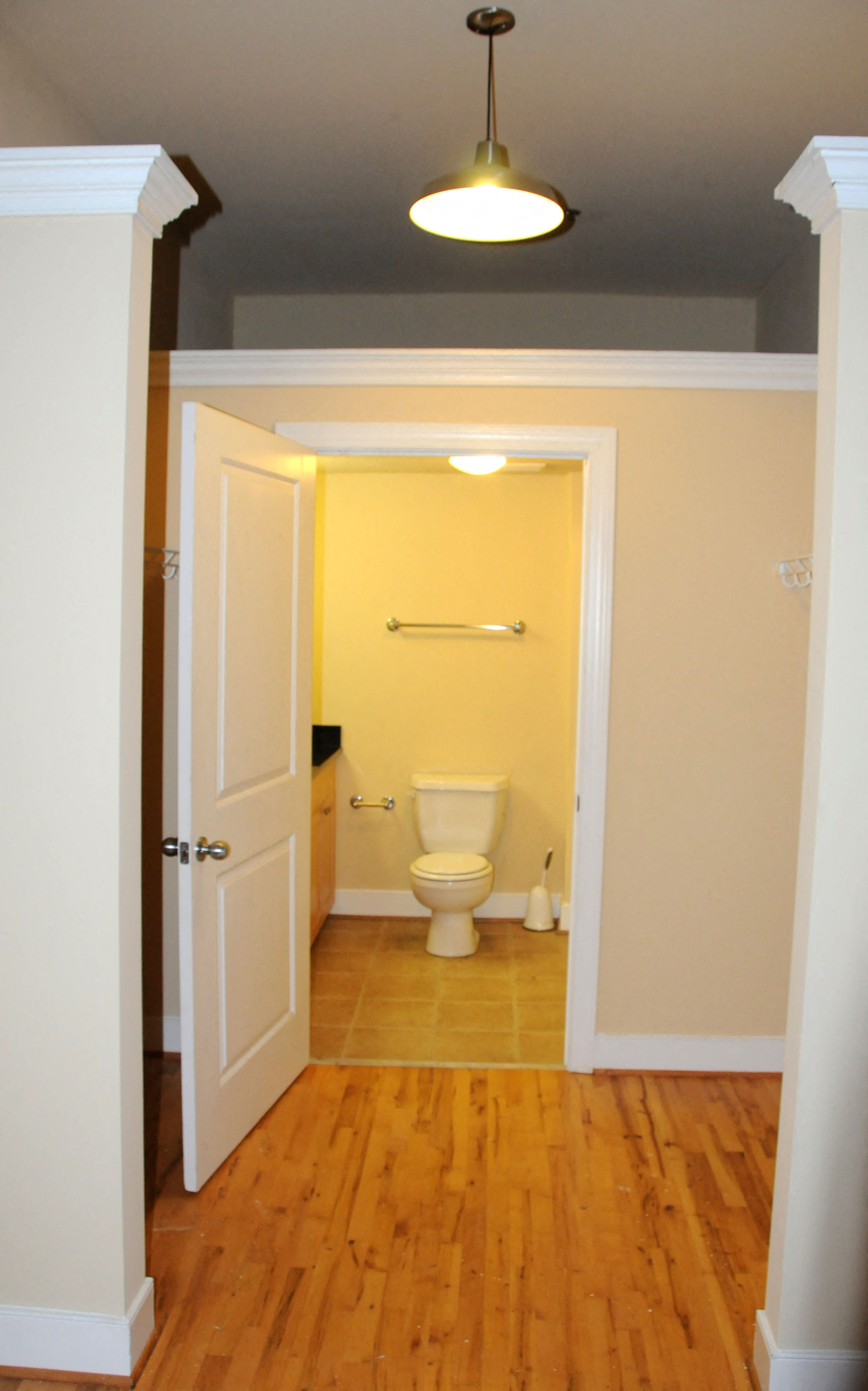 a small bathroom with a toilet and a door open