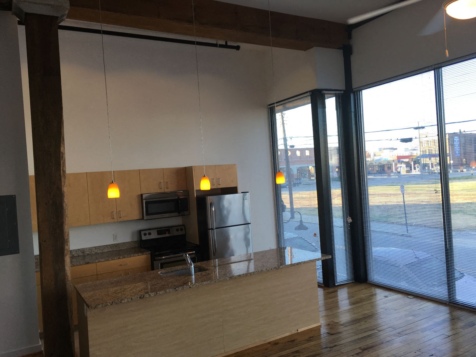an empty kitchen with a counter top and a refrigerator