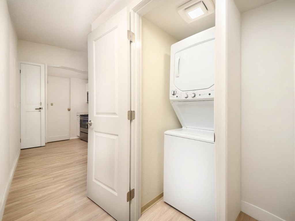 A white oven is built into a wall in a kitchen.