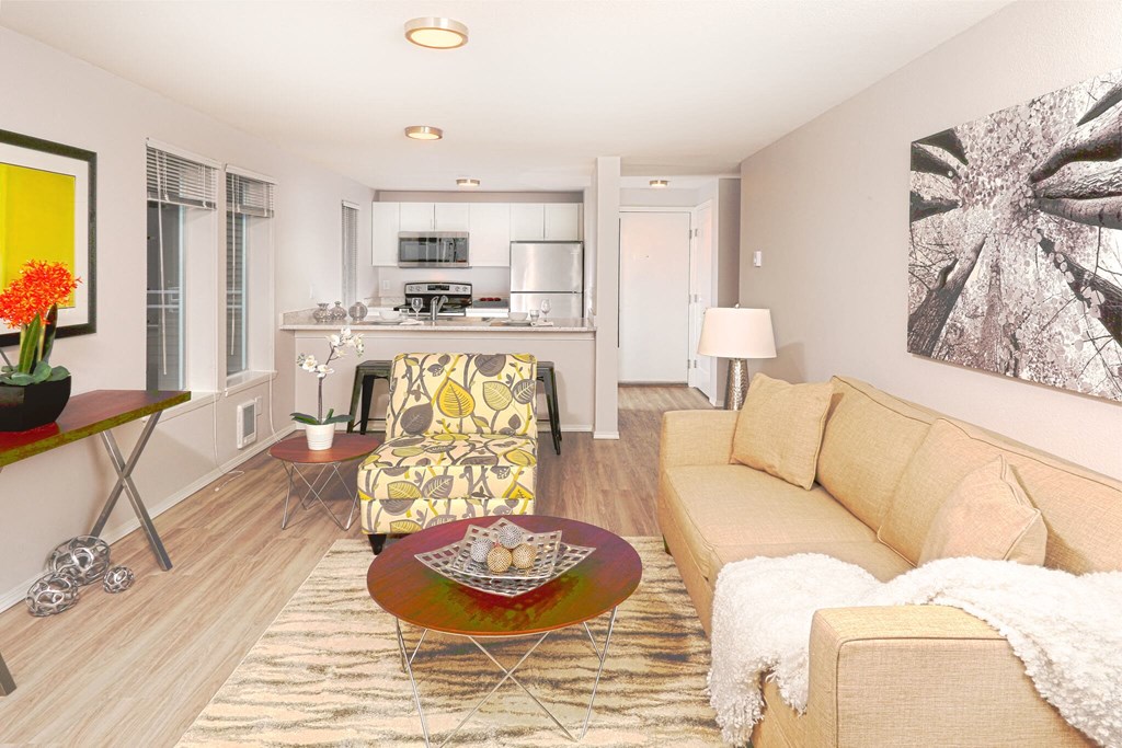 A living room with a yellow chair and a brown coffee table.