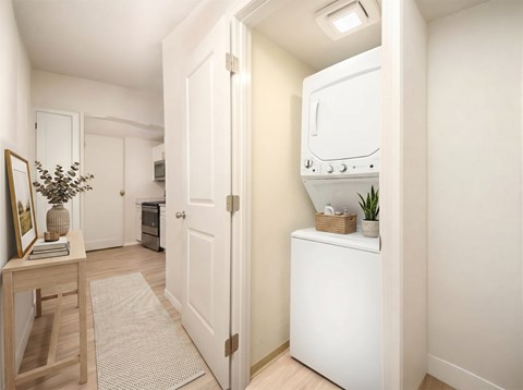 A white kitchen with a fridge, oven and microwave.