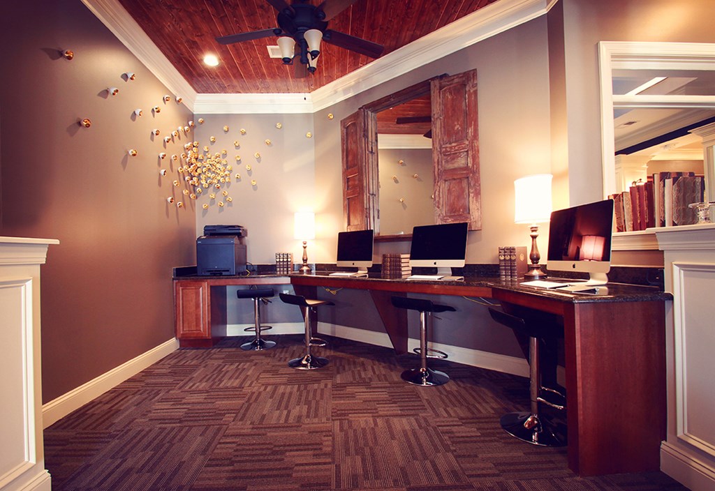 a desk with two computers and a mirror in a room