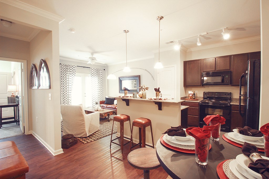 a view of the kitchen and living room from the dining room table