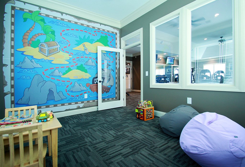 a play room with a large mural on the wall